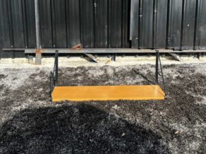 Hanging shelf, black steel frame, wooden top.