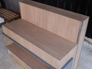 Product shelf, display stand, 1 side, wooden frame, brown wood pattern, has 1 compartment.