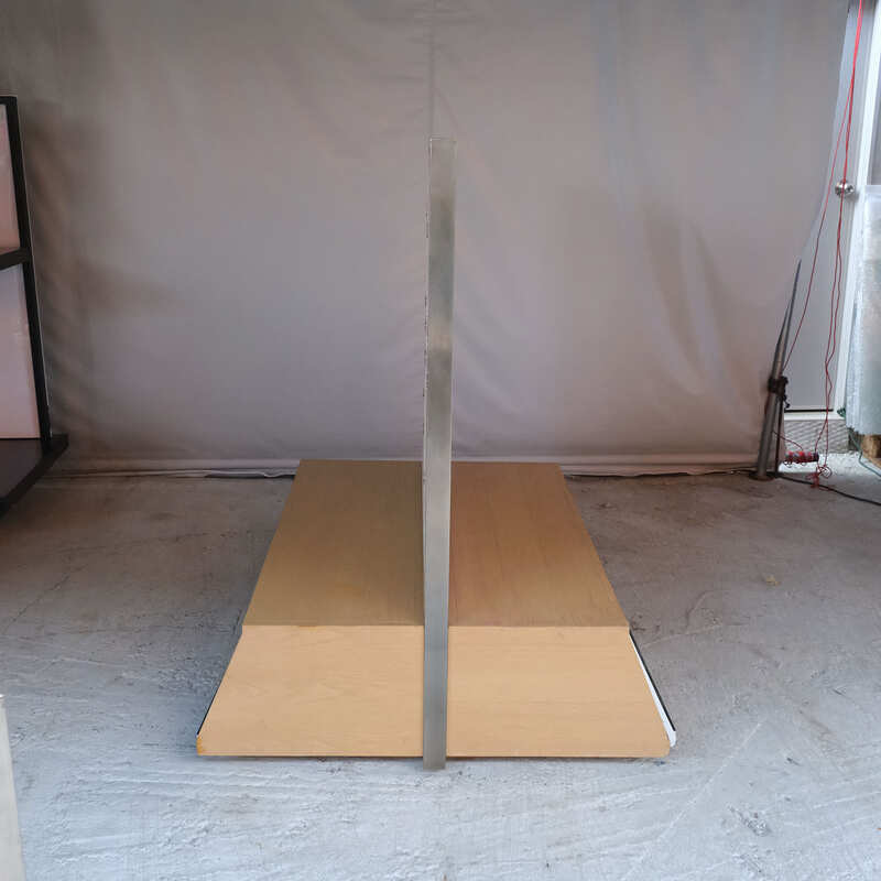 Product shelves, display stands, 2 sides, brown wooden base. Has a drawer in front of a mirror and has wheels