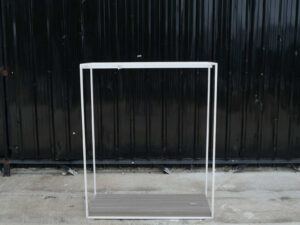 Open product shelves, with a hanging rail at the top. white steel frame Brown wood pattern base