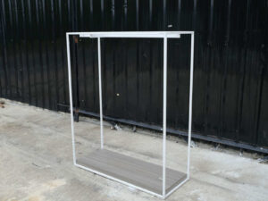 Open product shelves, with a hanging rail at the top. white steel frame Brown wood pattern base