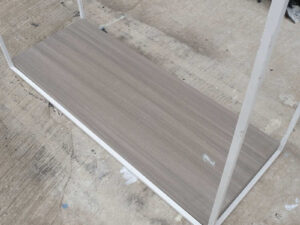 Open product shelves, with a hanging rail at the top. white steel frame Brown wood pattern base