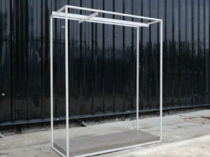 Open product shelves, with a hanging rail at the top. white steel frame Brown wood pattern base