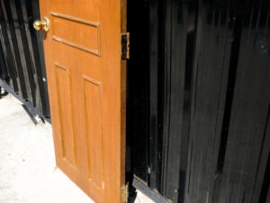 Wooden door, solid mullion door, hinges, gold knobs.