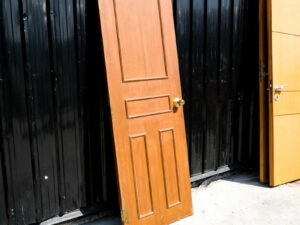 Wooden door, solid mullion door, hinges, gold knobs.