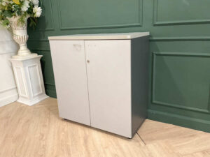 Filing cabinet, storage cabinet, wooden frame, white surface.