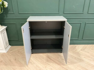 Filing cabinet, storage cabinet, wooden frame, white surface.