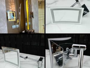 Shaving mirror in the bathroom, wall mounted, has built-in lights, steel cantilever legs.
