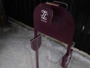 Tall product holder Product display box, red-purple color, attached to clear acrylic.