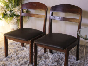Wooden chair with dark brown fabric cushion, beautiful design.
