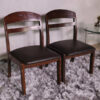 Wooden chair with dark brown fabric cushion, beautiful design.