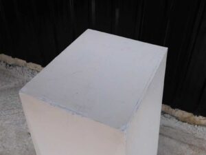Pallet Tall product display stand with white wooden frame all over.