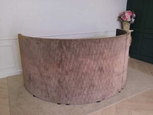 Semi-circular reception counter, cloth covered, wooden frame, brown.