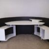 Semi-circular reception counter, cloth covered, wooden frame, brown.