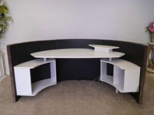 Semi-circular reception counter, cloth covered, wooden frame, brown.