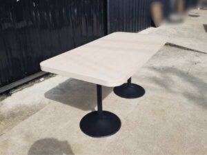 Dining table, black round steel legs, cream wood top, 160 x 80 cm.