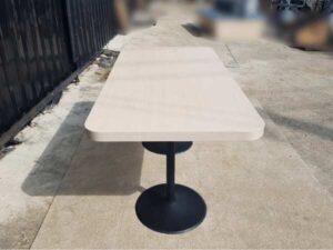 Dining table, black round steel legs, cream wood top, 160 x 80 cm.