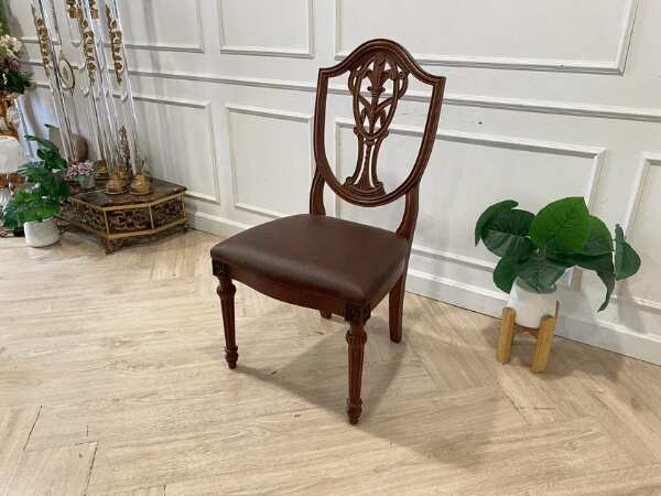 Dark brown vintage style wooden chair with leather seat