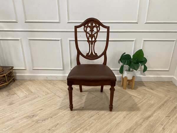 Dark brown vintage style wooden chair with leather seat