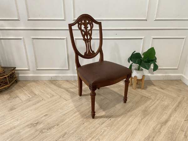 Dark brown vintage style wooden chair with leather seat