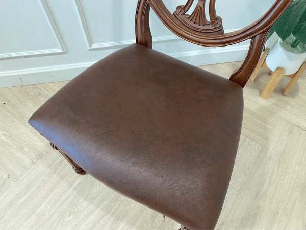 Dark brown vintage style wooden chair with leather seat