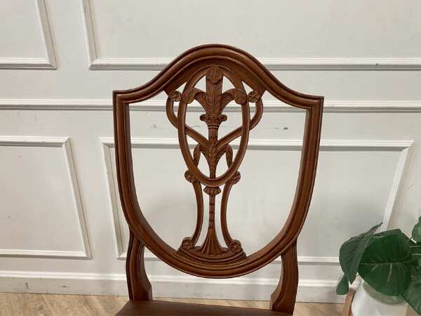 Dark brown vintage style wooden chair with leather seat