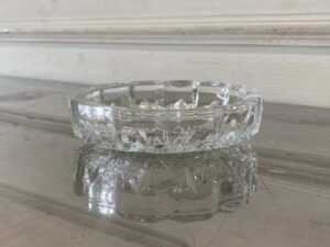 Thick, round crystal ashtray.
