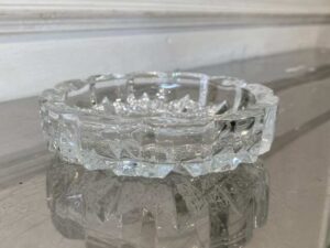 Thick, round crystal ashtray.