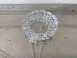 Thick, round crystal ashtray.