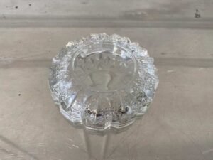 Thick, round crystal ashtray.