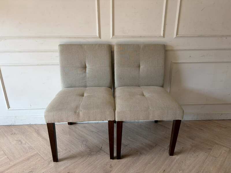 Modern style chair with grey fabric upholstery and wooden legs._11K3ZTNHRR