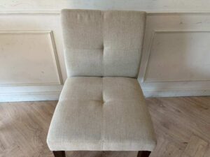 Modern style chair with grey fabric upholstery and wooden legs._11K3ZTNHRR