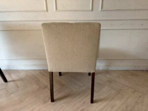 Modern style chair with grey fabric upholstery and wooden legs._11K3ZTNHRR