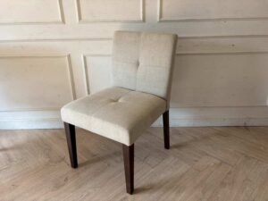 Modern style chair with grey fabric upholstery and wooden legs._11K3ZTNHRR