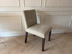 Modern style chair with grey fabric upholstery and wooden legs._11K3ZTNHRR