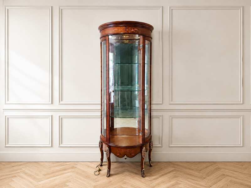 Glass display case with curved glass doors and a classic wooden frame.