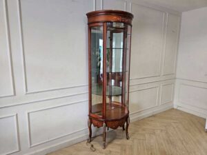 Glass display case with curved glass doors and a classic wooden frame.
