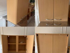 Wall-mounted storage cabinet with doors and shelves.