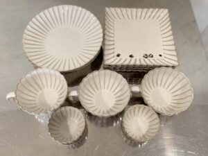 Set of white ceramic containers with striped pattern