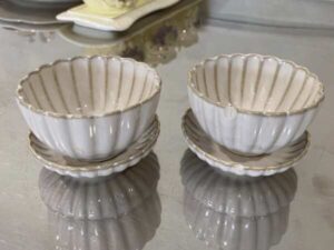 Set of white ceramic containers with striped pattern