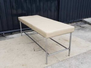 Spa massage bed with steel legs and leather cushion, cream color