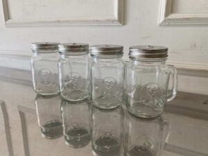 Set of clear glass Mason Jars with handles, embossed rooster design, Libbey brand.