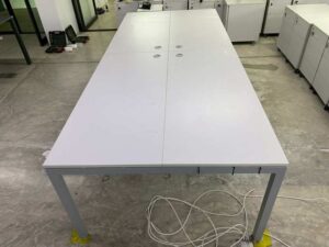 4-seater group workstation with grey steel legs and power strip.