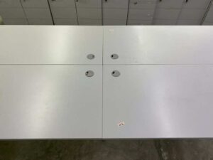 4-seater group workstation with grey steel legs and power strip.