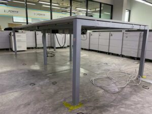 4-seater group workstation with grey steel legs and power strip.