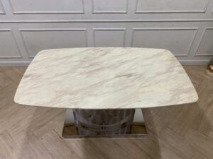 Dining table with stainless steel legs, leather upholstery, marble top