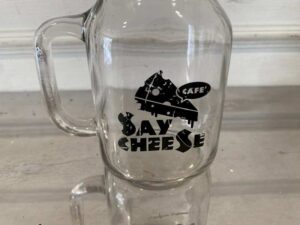 Clear glass mason jar with handle and lid.