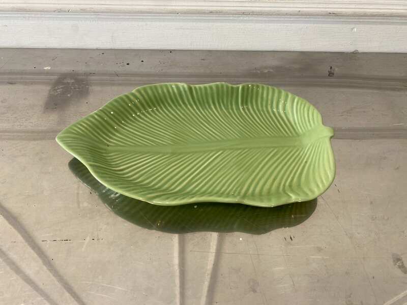 Ceramic plate with a green banana leaf design.