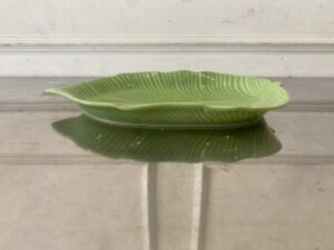 Ceramic plate with a green banana leaf design.