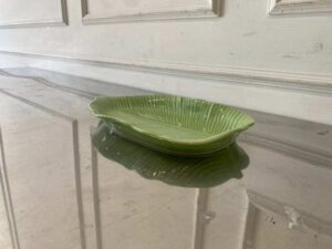 Ceramic plate with a green banana leaf design.